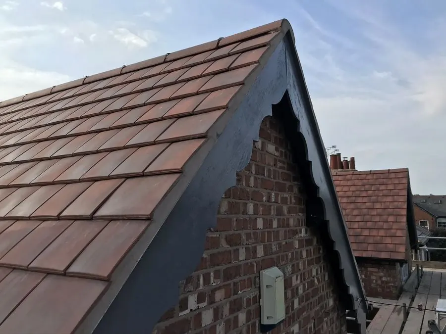 Brick house rooftop with reddish-brown tiles