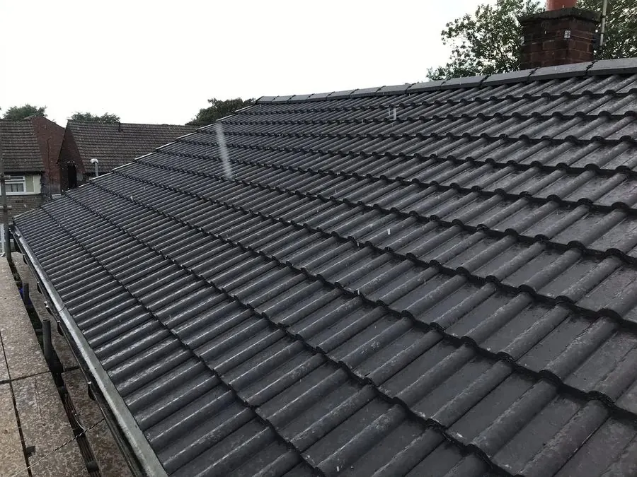 Gray tiled roof with brick chimney