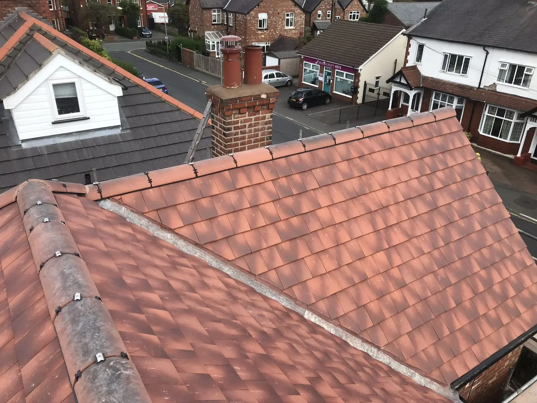 Aerial view of a red tiled roof in a Greater Manchester residential street